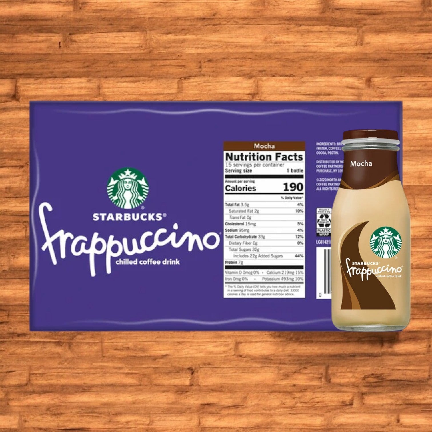 Image shows a 15-count pack of Starbucks Frappuccino Mocha Chilled Coffee bottles with nutrition facts on the packaging next to one bottle of the same 9.5 fl oz chilled coffee drink, all placed on a wooden surface. This ready-to-drink beverage from Starbucks Frappuccino is perfect for enjoying at home or on-the-go.