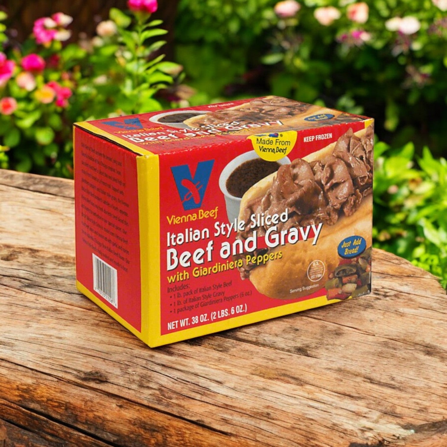 A 38 oz box of Vienna Beef Italian Style Sliced Beef and Gravy with Giardiniera Peppers rests on a wooden surface, showcasing its vibrant packaging, ideal for making authentic Italian beef sandwiches.