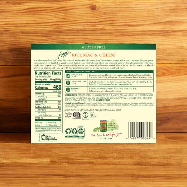 A box of Amy's Kitchen Gluten Free Rice Mac & Cheese, 9 oz. - 4 Count, is displayed on a wooden surface, highlighting the back with nutrition facts, ingredients, and preparation instructions for a convenient meal.