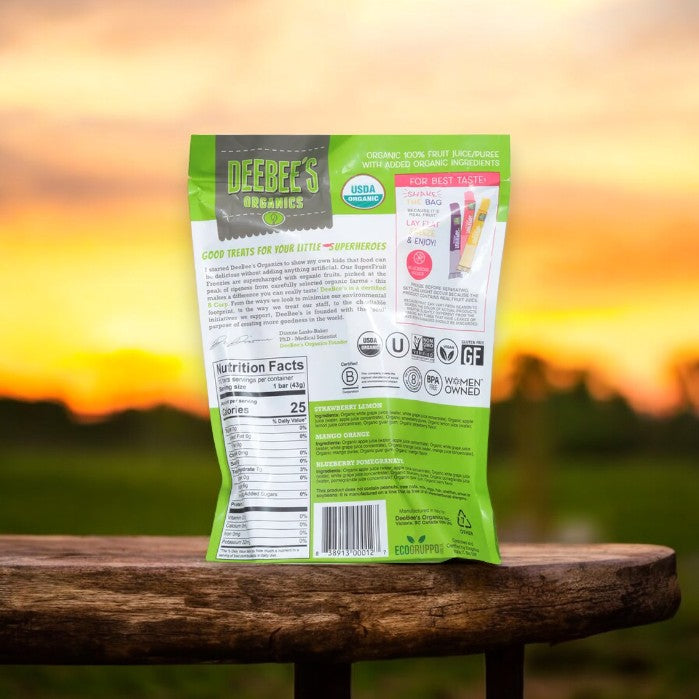 A back view of a colorful bag of DeeBee's Organics Freezie Pops, Organic - 10 -1.35 fl oz on a wooden surface with a sunset in the background. The gluten-free, plant-based packaging displays nutritional facts and certification labels.