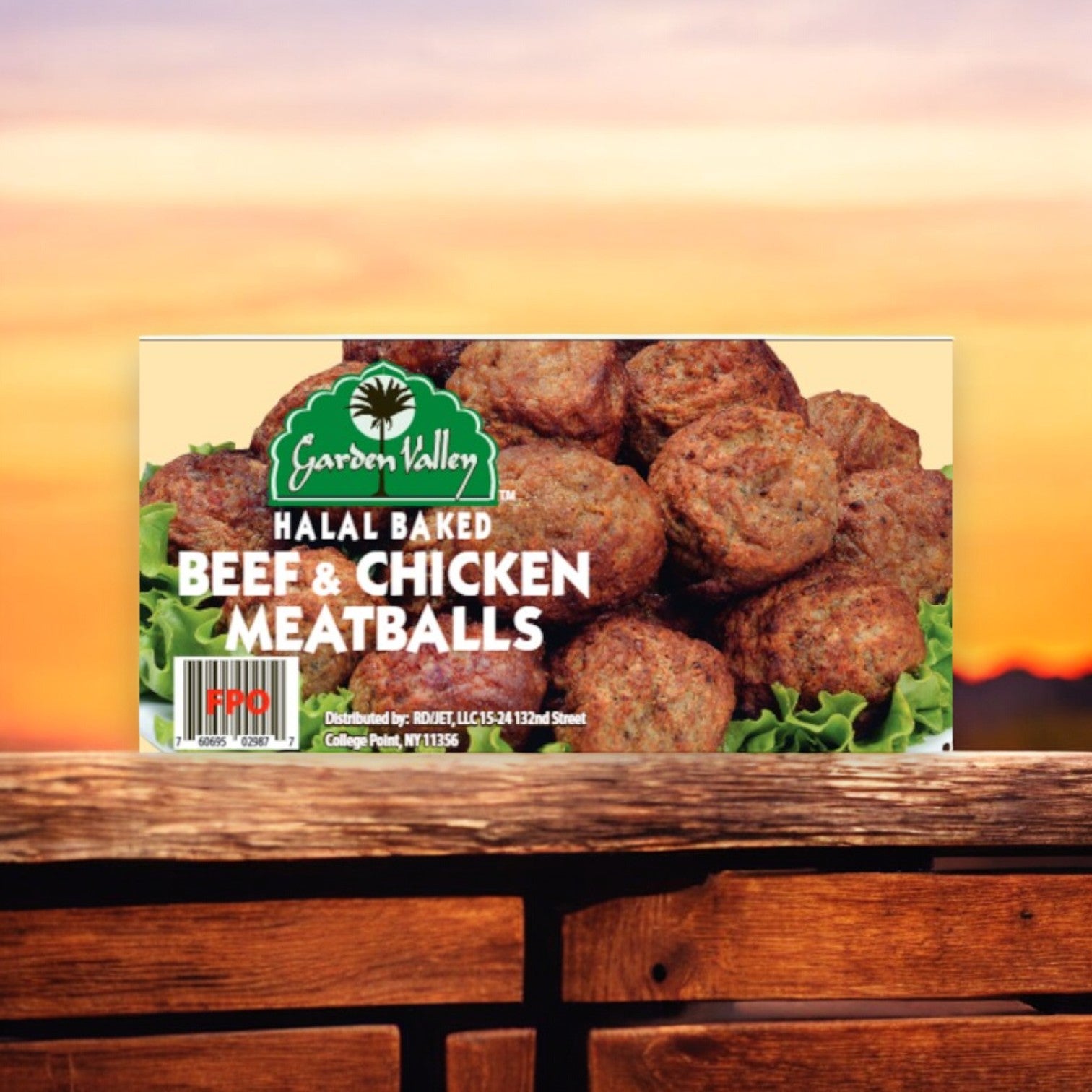 A 10 lb box of Frozen Garden Valley Halal 1oz Meatballs, Fully Cooked, rests on a wooden surface against a sunset backdrop, reminding one of the delightful taste of Halal Breaded Tenders with every savory bite.