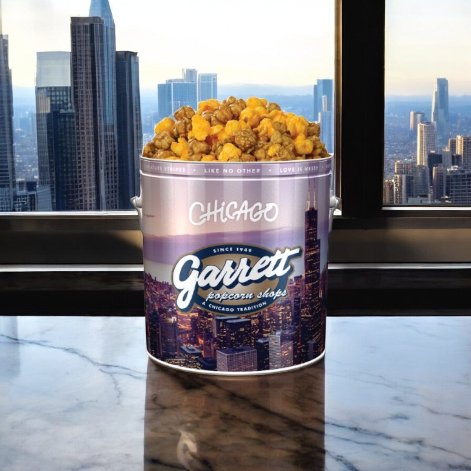 A large tin of Easy Lunches Garrett Popcorn, renowned as part of Chicago's culinary heritage, rests on a marble surface with the iconic skyline perfectly framed through the window behind it.