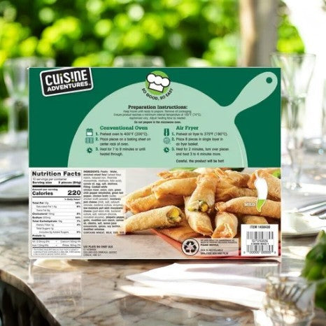 A box featuring Cuisine Adventure's Green Chile Chicken Firecrackers-1 Count rests on an outdoor table, showcasing preparation instructions and nutrition facts. The appetizers on the front are presented with a crispy golden shell, promising a bold and flavorful snacking experience.