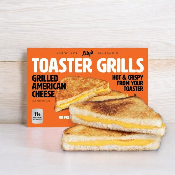 Box of Lily's Toaster Grills Grilled Cheese Sandwiches, on a wooden surface with two grilled cheese sandwiches in front. The box says "Hot & Crispy from your toaster." Perfect for a quick and convenient meal, these frozen delights bring deliciousness straight from the toaster to your table.