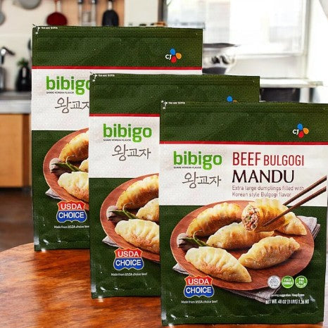 Three packs of Bibigo Beef Bulgogi Mandu-3 Count are displayed on a kitchen countertop.