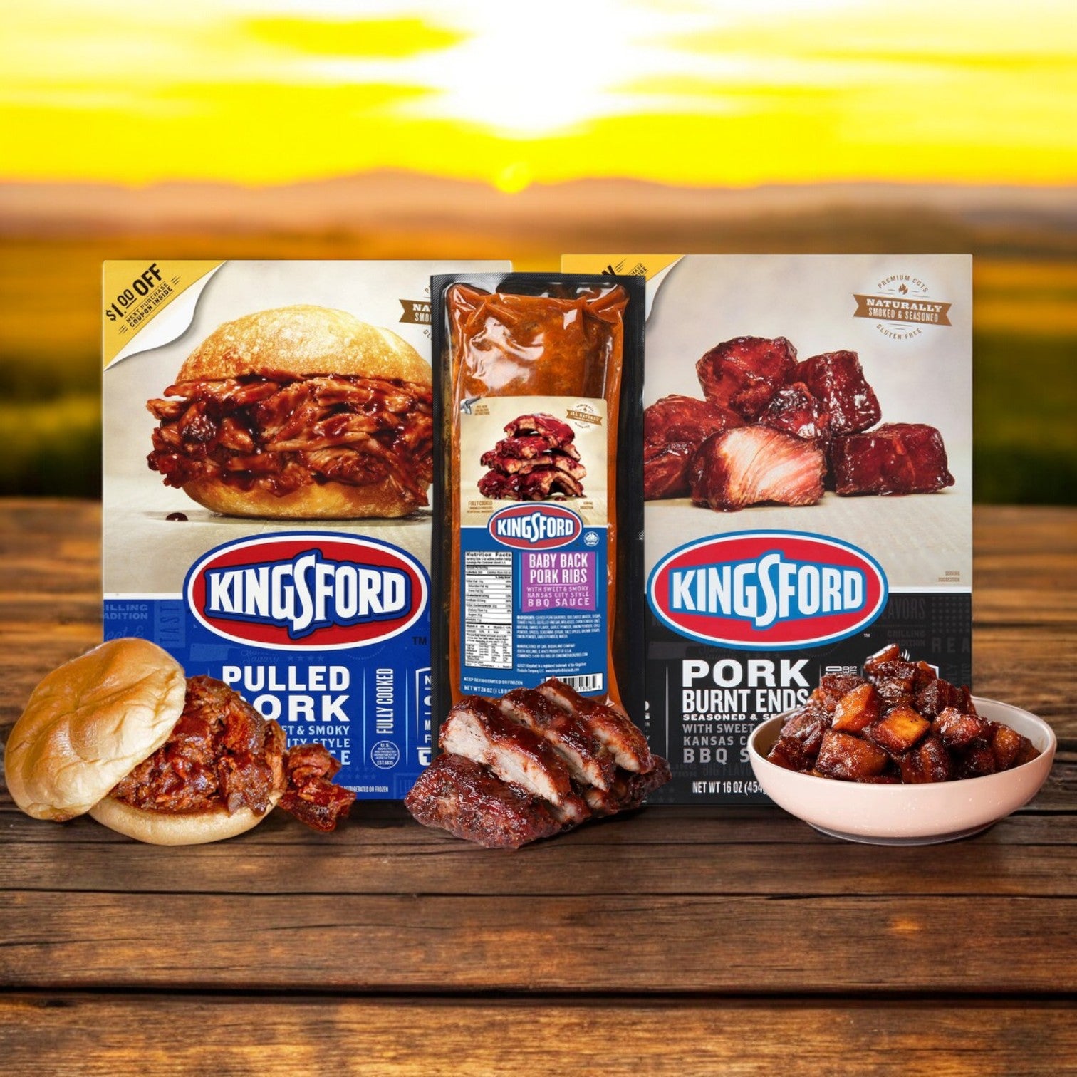 The Kingsford BBQ Feast, containing pulled pork, baby back ribs, and burnt ends, is elegantly displayed on a wooden surface with delectable servings in front, all set against a sunlit outdoor backdrop.