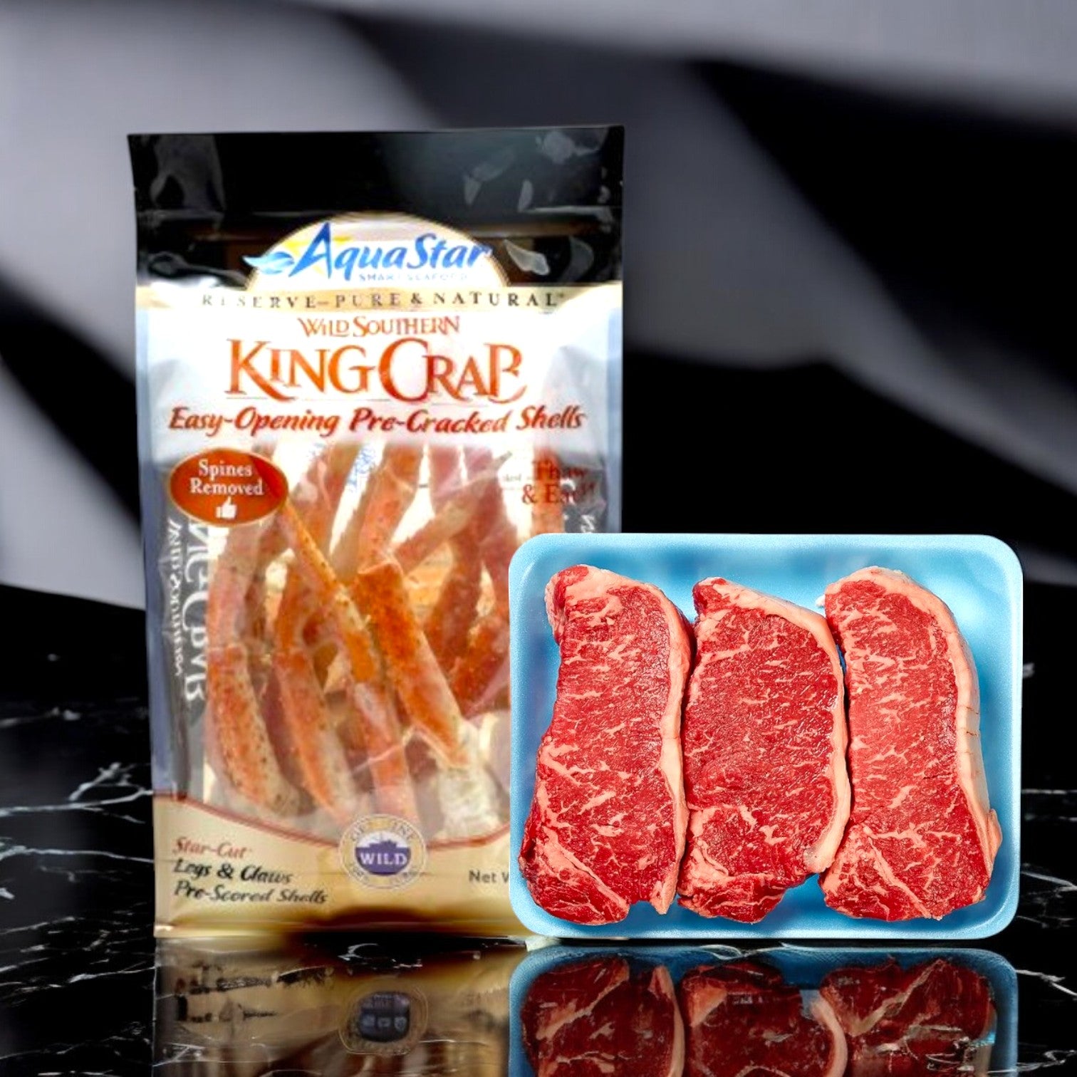 An Aqua Star Crab Legs and Claws combo, along with Beef Loin New York Steaks, is artistically arranged on a sophisticated black and white marble surface. Enjoy free shipping with Easy Lunches' exquisite presentation!