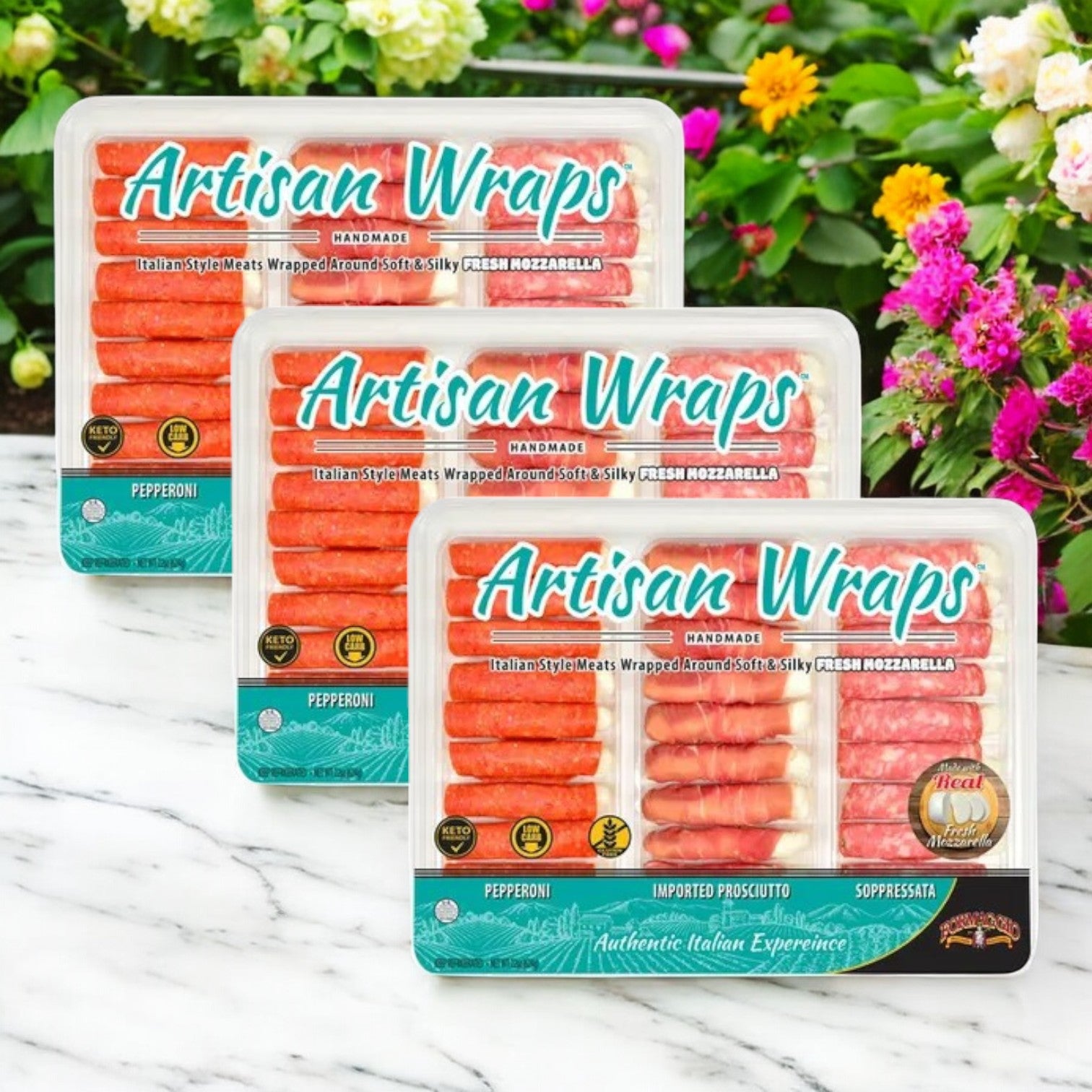 Three packages of Easy Lunches Formaggio Artisan Wraps, 22 oz. - 3 Count containing Italian-style meats and mozzarella are artfully displayed outdoors. This gourmet snack offers Pepperoni, Imported Prosciutto, and Soppressata for a delectable experience.