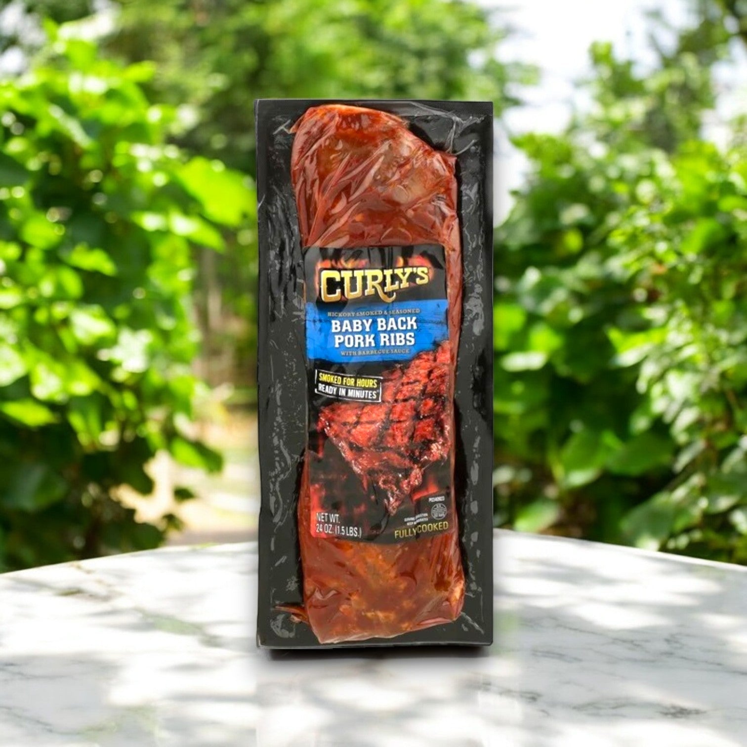 A slab of Curly's BBQ & Ribs – 24 oz-3 Count, celebrated for its authentic BBQ flavor, is displayed upright on a marble surface with softly blurred greenery behind.