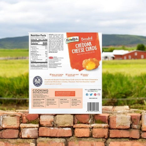 A 2.5 lbs box of Farm Rich Breaded Cheddar Cheese Curds rests against a brick wall with a farm scene behind it, ideal as a tasty snack or appetizer combining tradition and flavor.