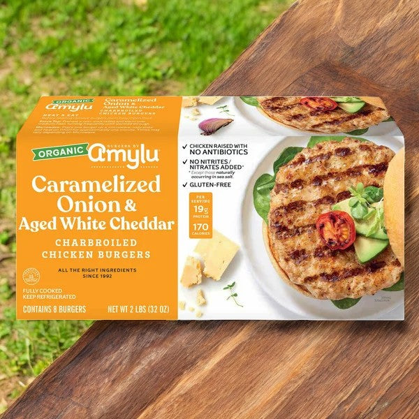 The packaging for Amylu's 32 oz, 8-count Caramelized Onion and Aged White Cheddar Chicken Burgers highlights the use of all-natural ingredients and underscores their gluten-free characteristics, reflecting a dedication to promoting healthy eating.