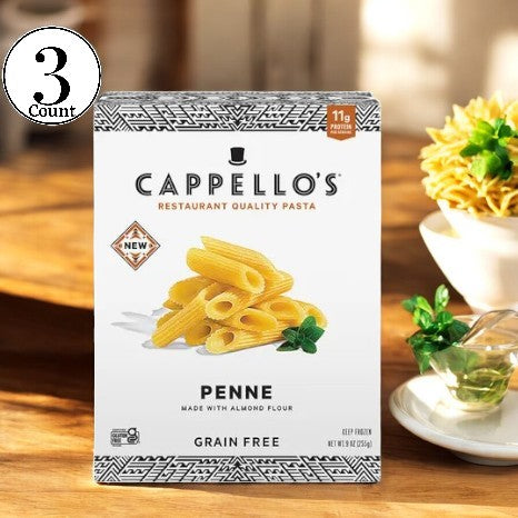 A box of Cappello's Penne Pasta- 3 Count is elegantly displayed on a wooden table, accompanied by a small plant and decorative flowers in the background.