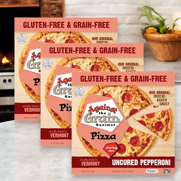 Three boxes of Easy Lunches' Against The Grain Gluten & Grain Free Uncured Pepperoni Pizza, Sharing Size, 15 oz. Each package features an enticing image of the pizza and prominently highlights its Vermont origin label, all beautifully displayed on a wooden surface.