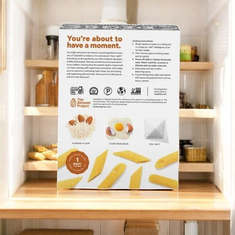 Back of a Cappello's Penne Pasta box on a kitchen counter, featuring their almond flour penne. It includes gluten-free ingredients and cooking instructions for a wholesome meal experience.