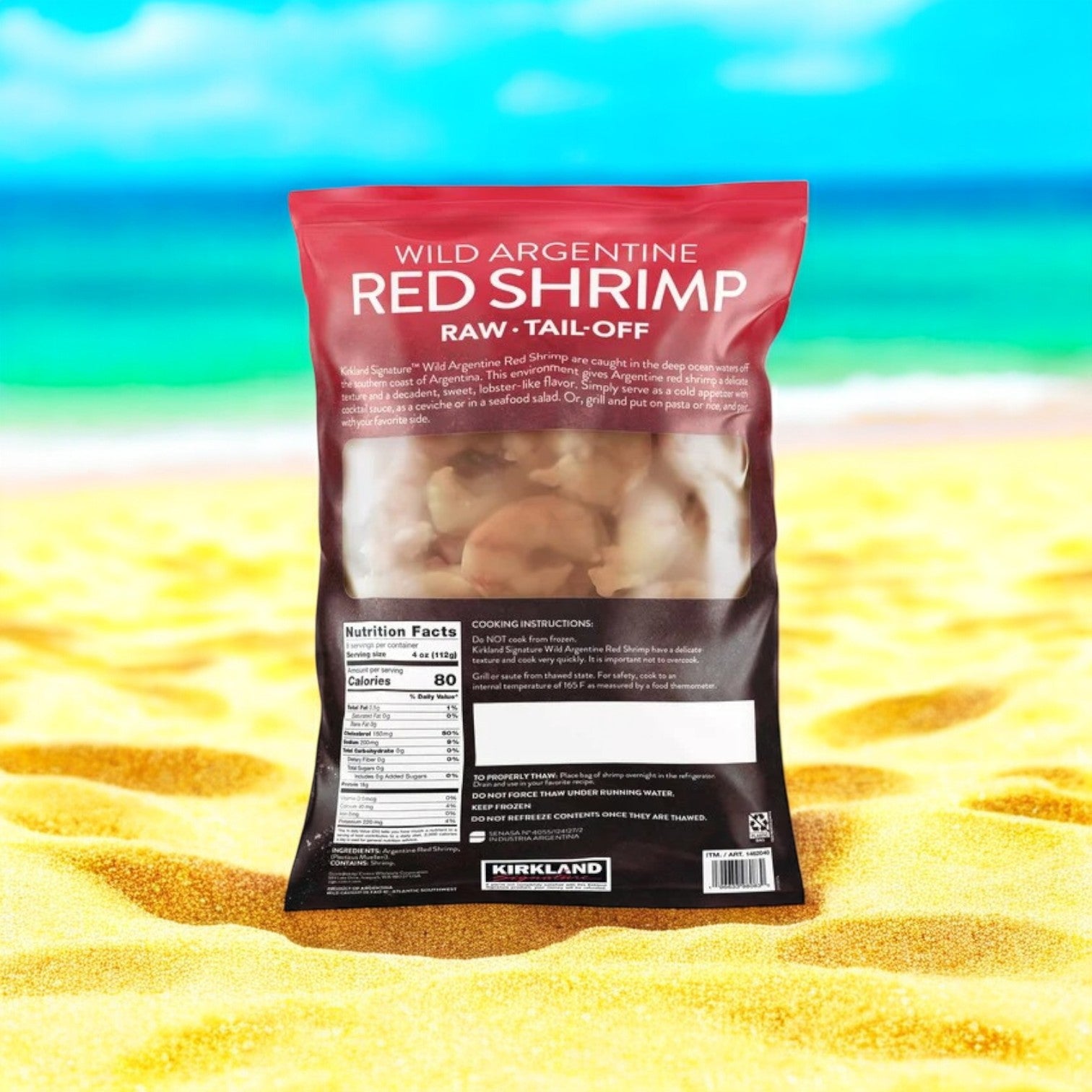 A 2 lb pack of Kirkland Signature Argentine Red Shrimp, 20-40 count, sits on a sunny beach backdrop. The bag features nutrition facts, cooking instructions, and branding, highlighting its quick-freezing technology to ensure freshness.