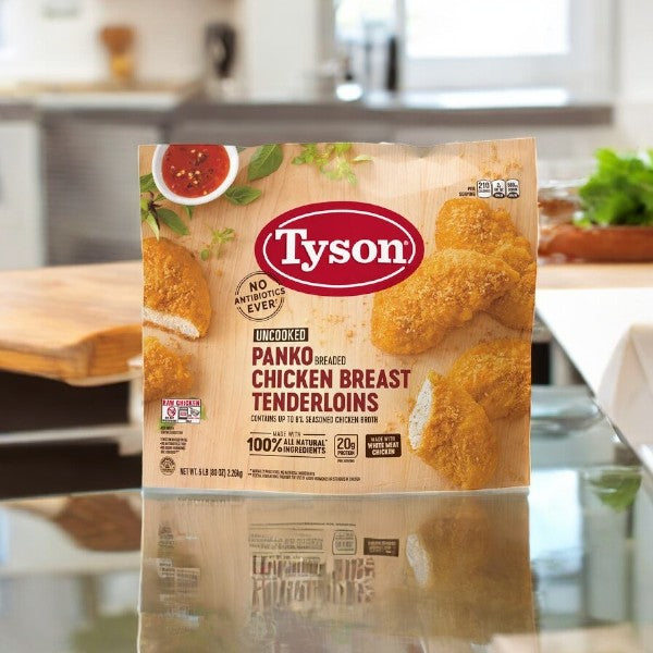 A 5 lb package of Tyson Panko Breaded Chicken Breast Tenderloins is on the kitchen counter, flaunting its fully cooked, crispy perfection.