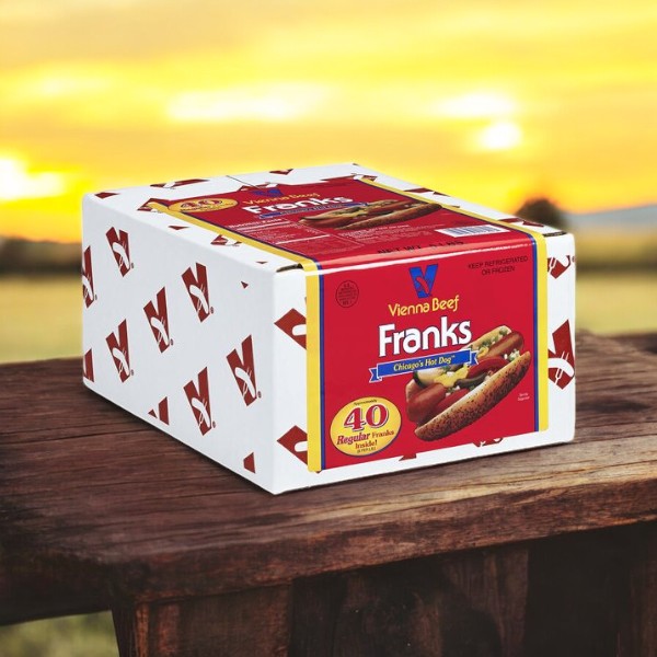 A 5lb box of Vienna Beef Franks, featuring a total of 40 high-quality franks renowned for their signature flavor, rests invitingly on an outdoor wooden table, its label proudly displaying tempting hot dogs.