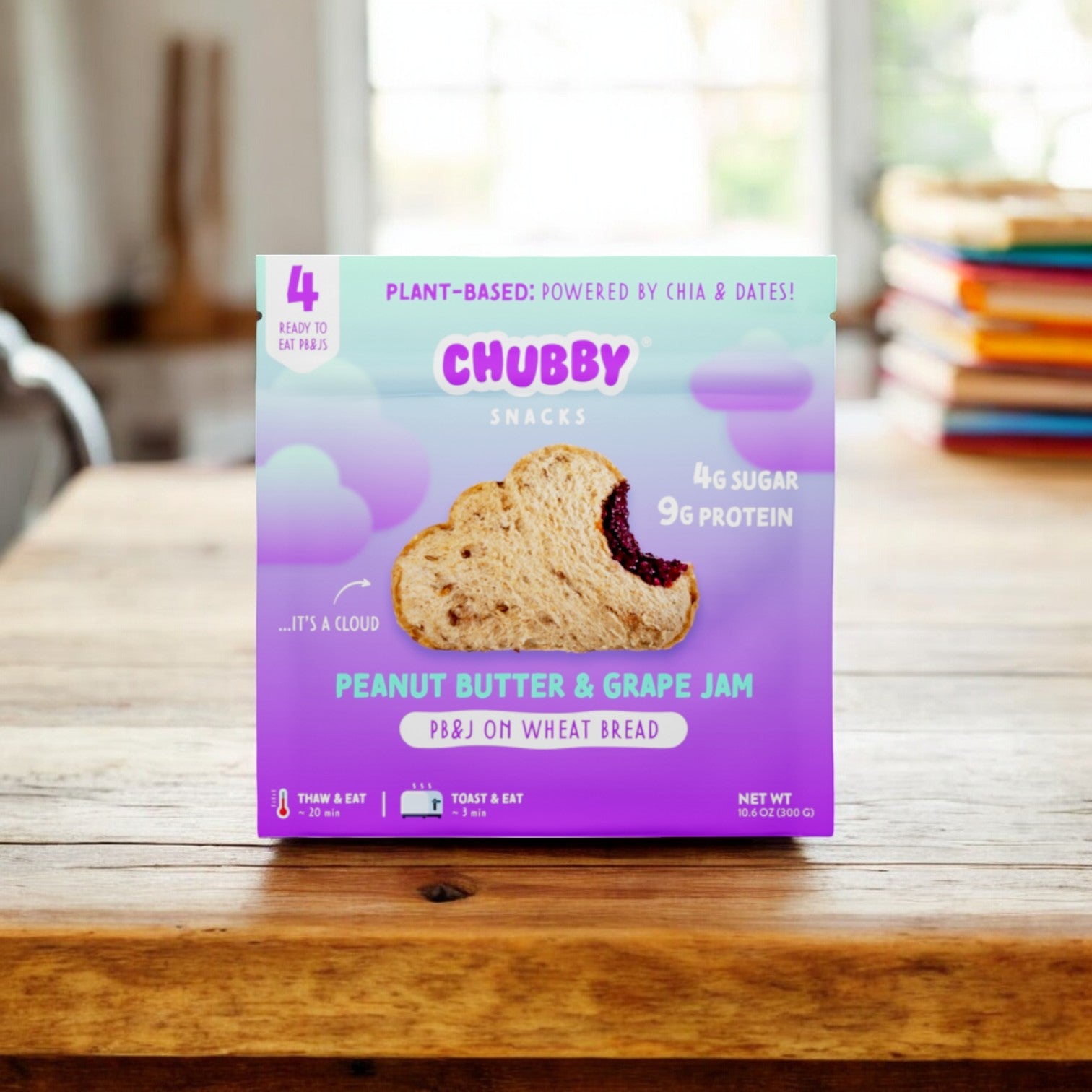 A Chubby Snacks package featuring the Peanut Butter & Grape Jam sandwich on wheat bread is placed on a wooden table. The packaging highlights its plant-based ingredients and nutritional value.