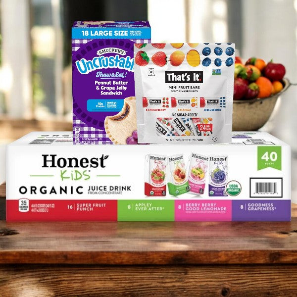 An Easy Lunches Kids Bundle, featuring 18 Grape Jelly Uncrustables, 24 That's it Assorted Fruit Bars, and 40 Assorted Honest Kids Juice Boxes, is conveniently placed on the counter.