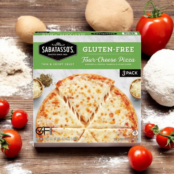 Savor Sabatasso's Four Cheese Pizza with a stone-baked crust and visible ingredients like ripe tomatoes, fine flour, and dough in the background, enhanced by the rich taste of mozzarella.