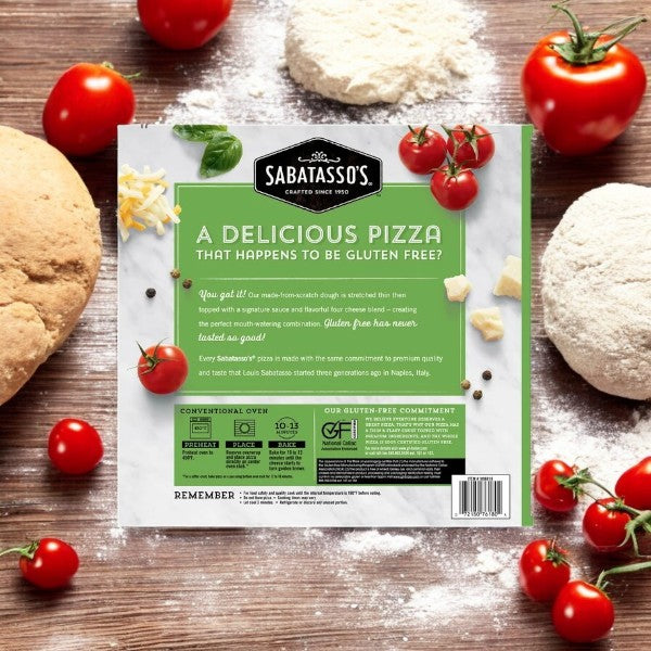 Pizza packaging enveloped by dough, mozzarella, tomatoes, and flour, showcasing Sabatasso's Four Cheese Pizza—a delicious gluten-free option with a stone-baked crust.