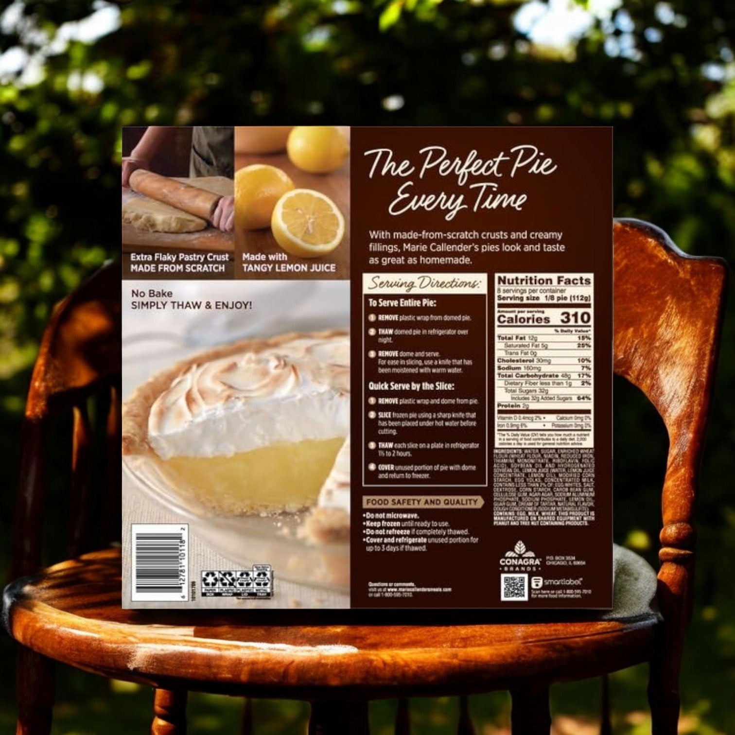 A package of Marie Callender's Lemon Meringue Pie Frozen Dessert (31.5 oz, 3 count) sits on a wooden chair, featuring its flaky crust and tangy citrus taste, with nutritional facts and preparation instructions clearly marked on the packaging.