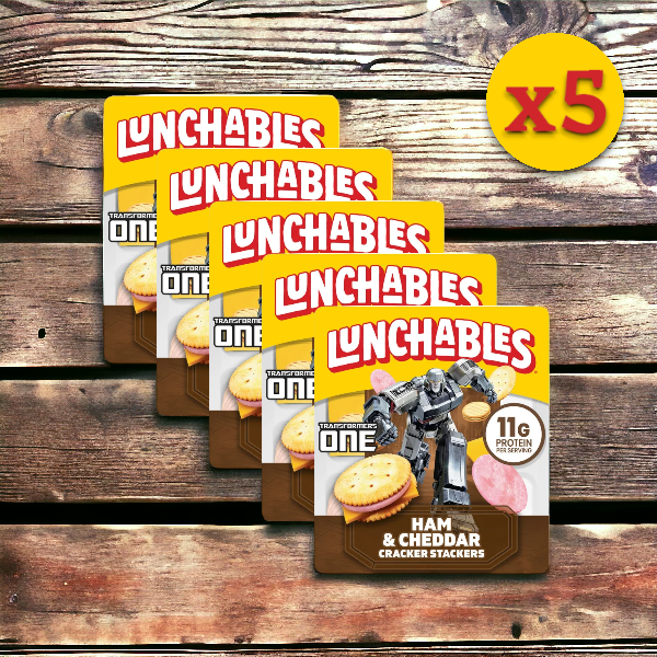 Five Lunchables Ham & Cheddar Cheese, 3.5 oz. - 5 Pack Bundle from the Lunchables brand with a Transformers theme are arranged in a diagonal line on a wooden surface, featuring a yellow "x5" label in the top right corner.