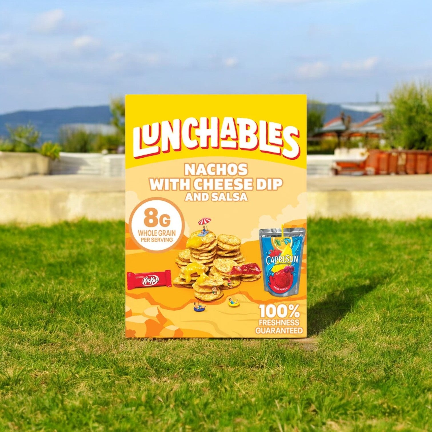 A selection from the Lunchables Variety Bundle, specifically the Lunchables Nachos with Cheese Dip and Salsa, showcasing 8g of whole grain per serving and accompanied by a Capri Sun drink pouch, displayed outdoors on grass against a scenic background. This bundle is part of the popular assortment that includes 40 packs: 10 Nachos With Cheese Dip, 10 Pizza Treatza, 10 Extra Cheesy Pizza, and 10 Chicken Nugget Kabobbles—perfect for quick meal solutions.