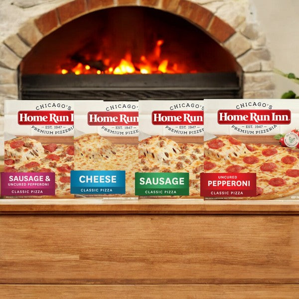 Four Easy Lunches Home Run Inn Variety Pack pizzas, including a delicious assortment of Sausage Pizza, Sausage & Pepperoni Pizza, Pepperoni Pizza, and Cheese Pizza, are displayed in front of a brick oven with a fire inside.