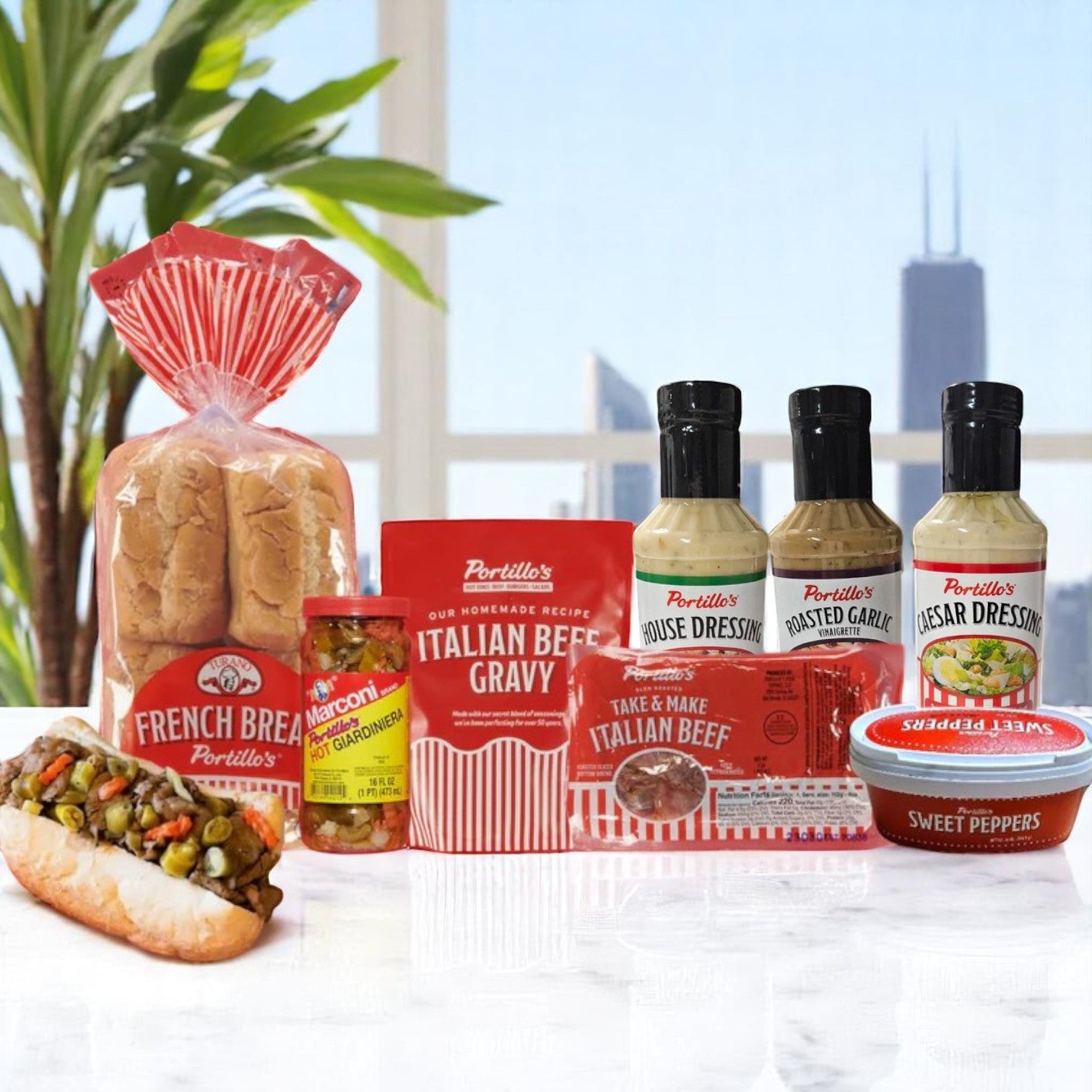 Portillo's Italian Beef Bundle with Condiments and 3 Dressings, featuring bread, gravy, sweet peppers, Hot Giardiniera, and salad dressings by Portillo’s, displayed with an Italian Beef sandwich against a cityscape background.