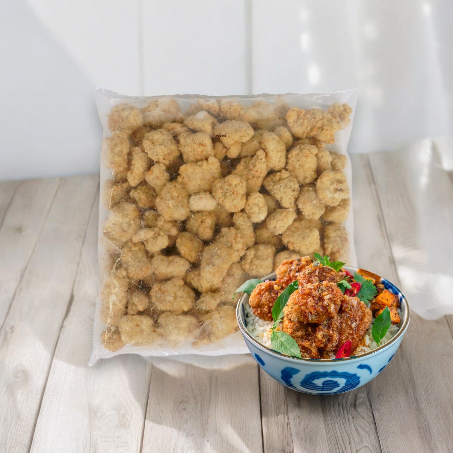 A sealed bag of Sysco Classic Chicken Wing Boneless Fully Cooked Gluten-Free Halal sits beside a bowl of cooked, Halal chicken wing nuggets, garnished with herbs and chili.