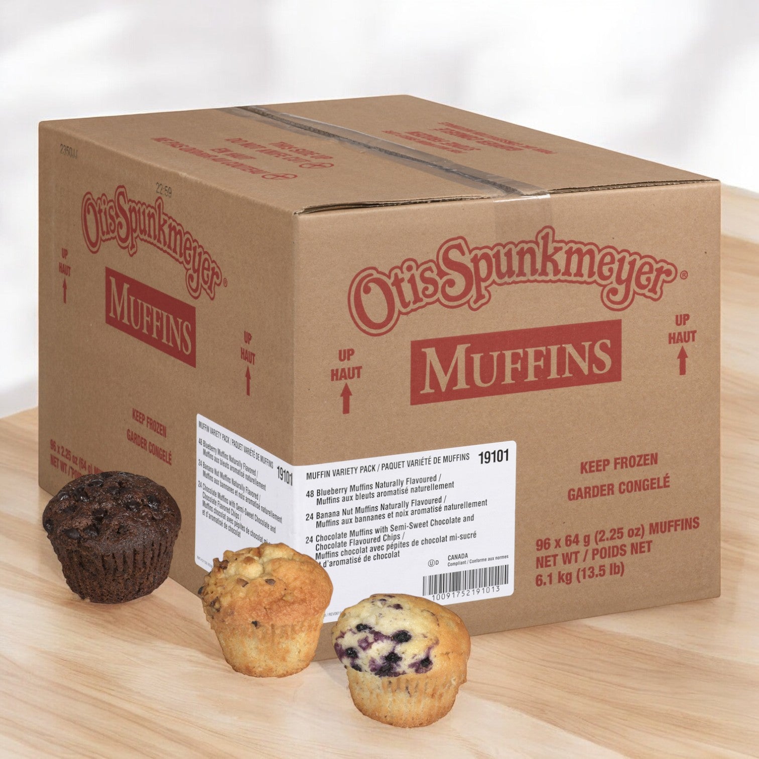 A cardboard box from Otis Spunkmeyer showcases their Muffin Variety, featuring three enticing flavors: chocolate chip, blueberry, and banana nut. Indulge in the decadent chocolate chip variety that matches the richness of the finest brownies—all provided in a bulk case for guaranteed freshness, with a total of 96 muffins.