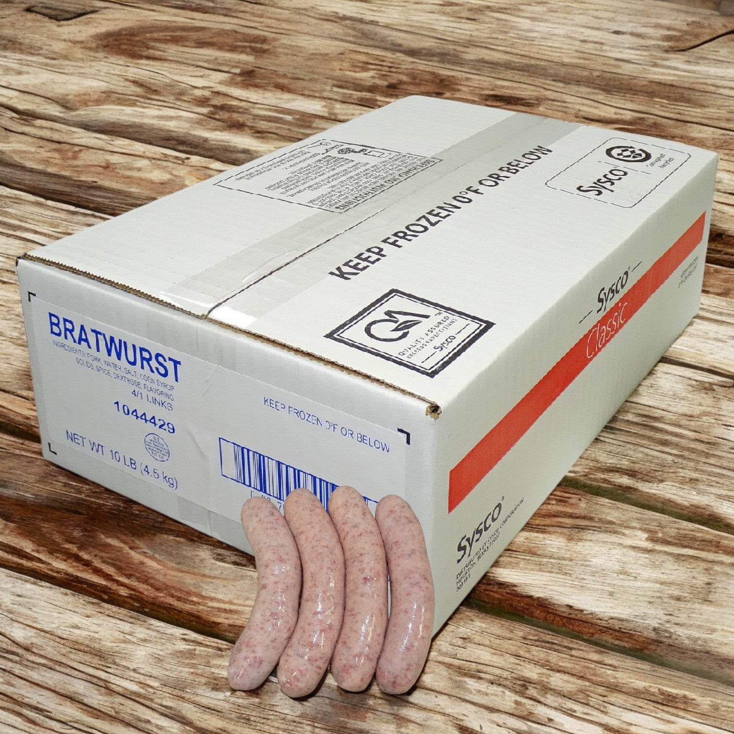 A box labeled "Sysco Classic Bratwurst" rests on a wooden surface with four raw sausages in natural casing against it. The label shows the weight and grilling instructions and reminds users to keep the product frozen.