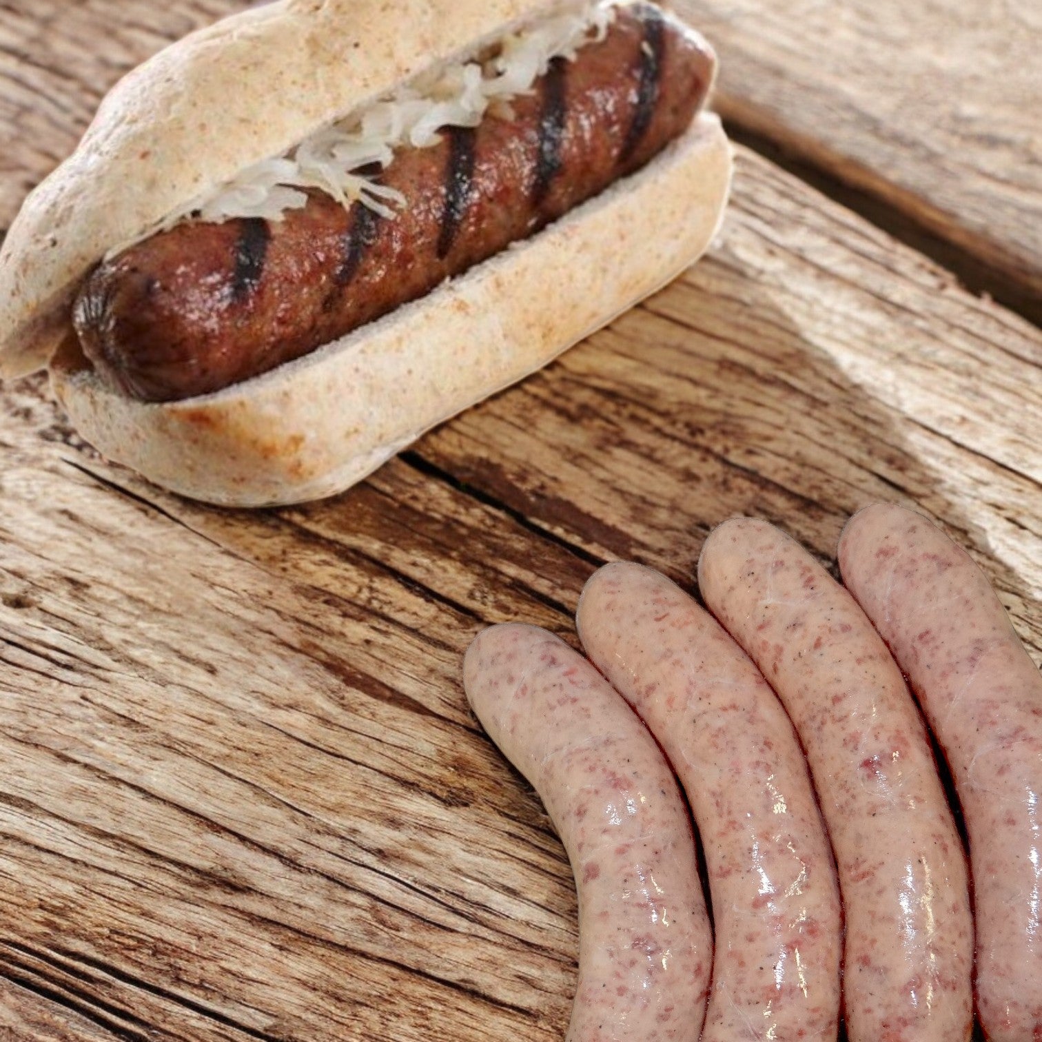 A grilled Sysco Classic Bratwurst, nestled in a bun with sauerkraut, rests on a wooden surface alongside four uncooked Sysco bratwursts, highlighting the art of grilling.