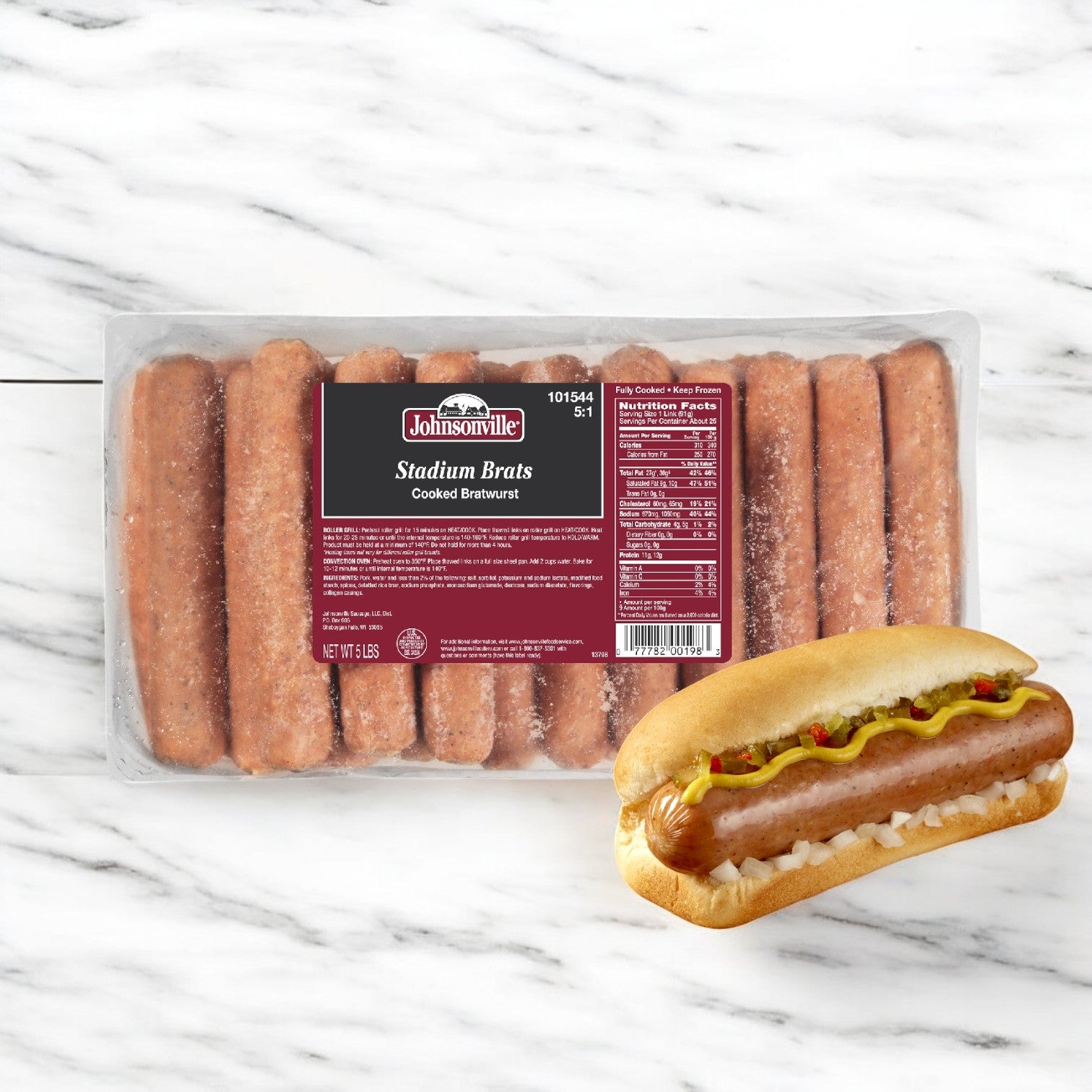 On a marble surface lies a package of Johnsonville Foods Bratwurst 5 Per # Pre-cooked 5.5" A-c (2/5 lbs). Nearby, a savory pre-cooked brat in a bun is topped with mustard and onions.