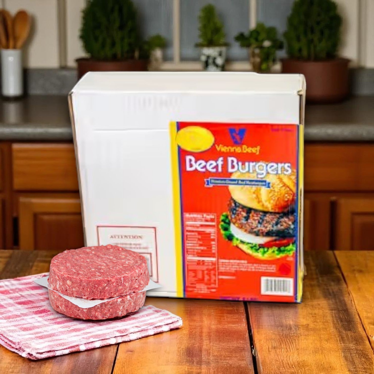 A box of Vienna Beef 5:1 Pure Beef Burgers sits on a kitchen counter, with an uncooked 3.25 oz patty placed on a striped towel in front, showcasing Vienna Beef quality—50 patties included.