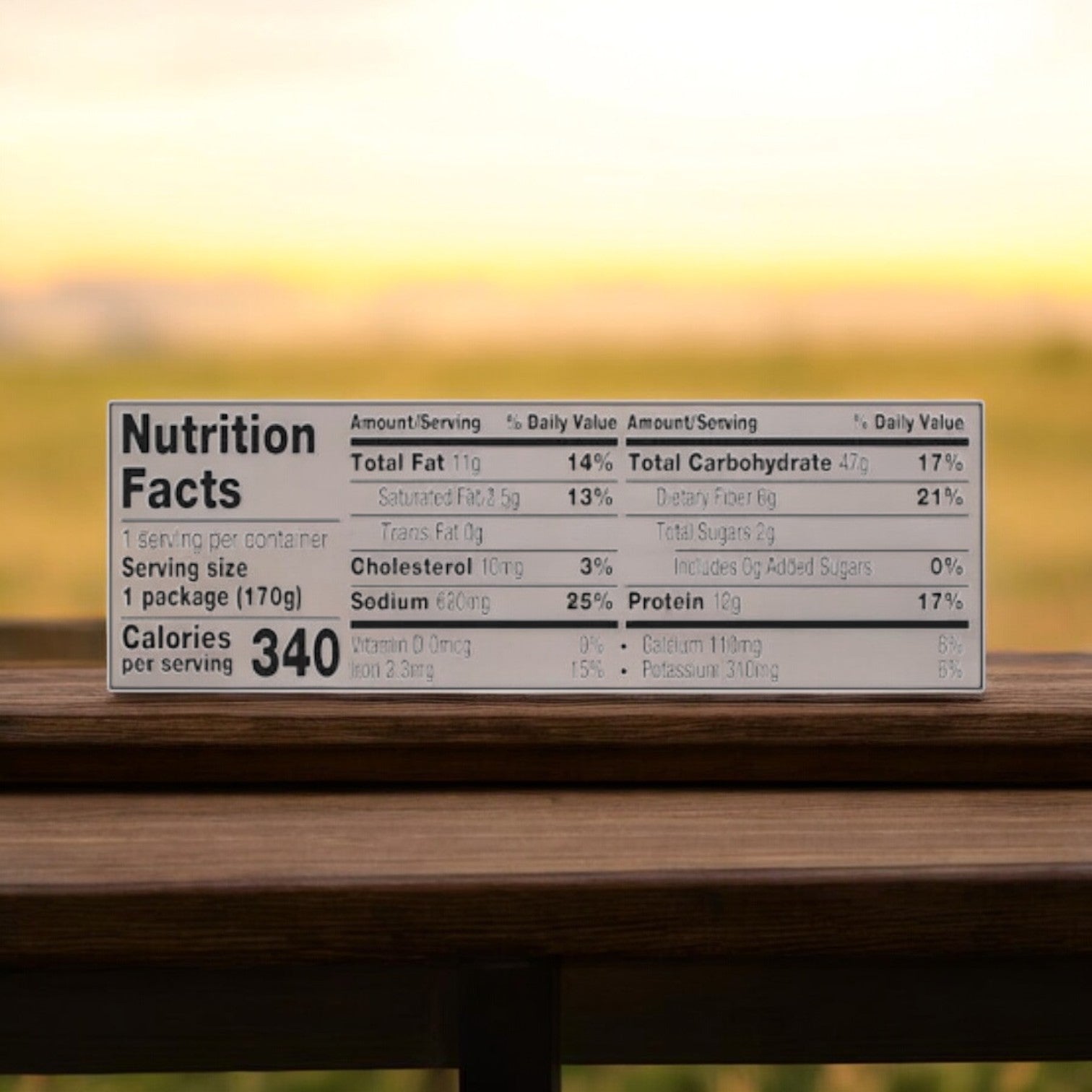 Close-up of a nutrition facts label on a 170g package of Amy's Burrito and Cheddar Cheese from the Amy's Burrito 6 Pack, listing 340 calories per serving, with detailed breakdowns of fats, cholesterol, sodium, carbohydrates, and protein. Background is blurred.