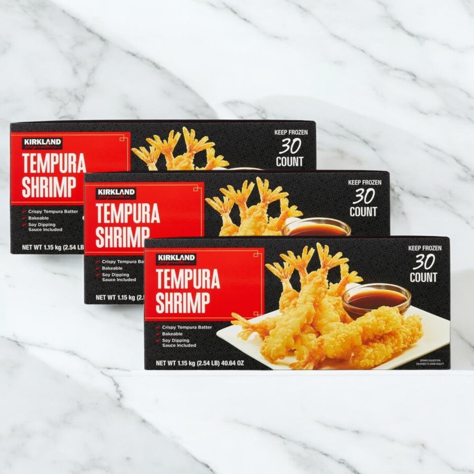 Three boxes of Easy Lunches Kirkland Signature Tempura Shrimp, 2.35 lbs each with 30 pieces, are displayed on a white marble surface.