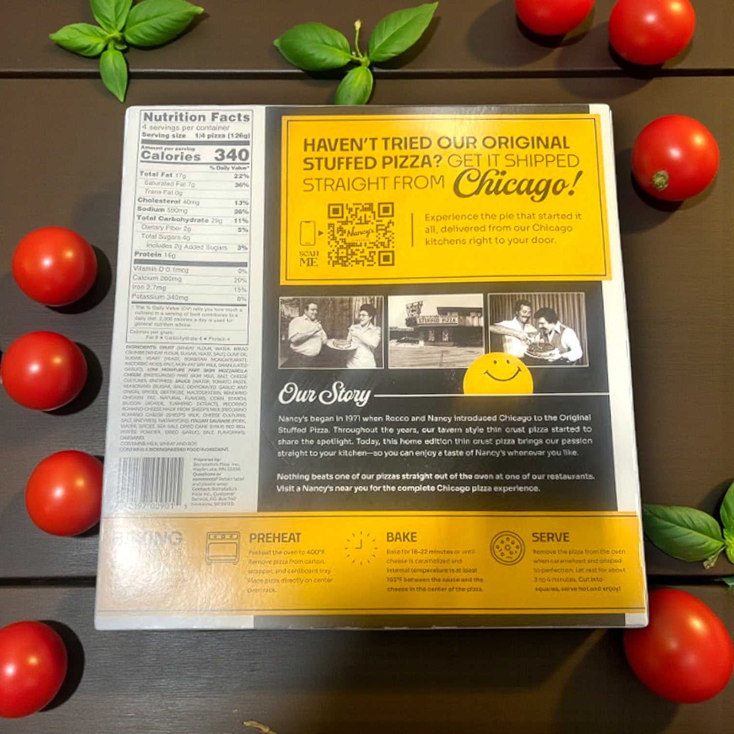 The back of the Nancy’s Pizza- Home Edition Chicago Style Thin Crust Italian Sausage Pizza (17.76 oz) box from Nancy's Pizzeria displays nutrition facts, baking instructions, a company story, and a shipping promo, with tomatoes and basil artfully arranged around it.