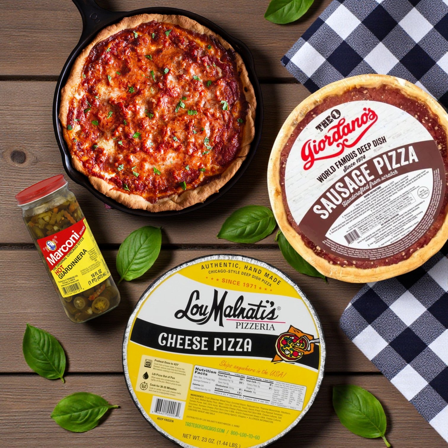Chicago’s Deep Dish Duo with a Kick! from Chicago's Best – Iconic Eats from the Windy City sits on a wooden table, featuring stuffed pizza, cheese pizza, giardiniera, fresh basil leaves, and a plaid napkin for an authentic Chicago experience.