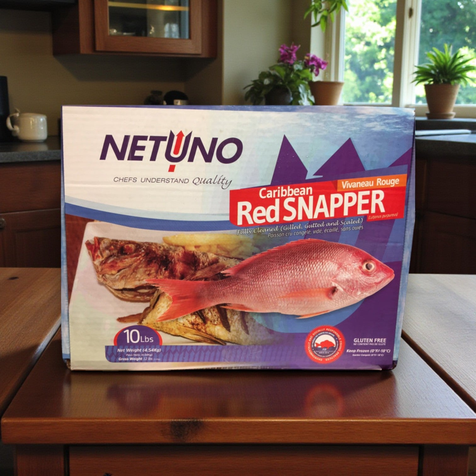 A 10 lb box of Netuno Frozen Whole Caribbean Red Snapper (¾ to 1 lb each) rests on the counter, with packaging showing the fish and features like "wild-caught," "gluten free," and "Vivaneau Rouge.