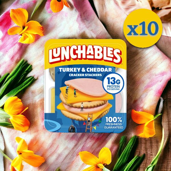 A 10-pack bundle of Lunchables Turkey & Cheddar Cheese, a convenient meal, is displayed alongside yellow flowers. The package highlights "13g Protein" and "100% Freshness Guaranteed." A "x10" label is in the upper right.