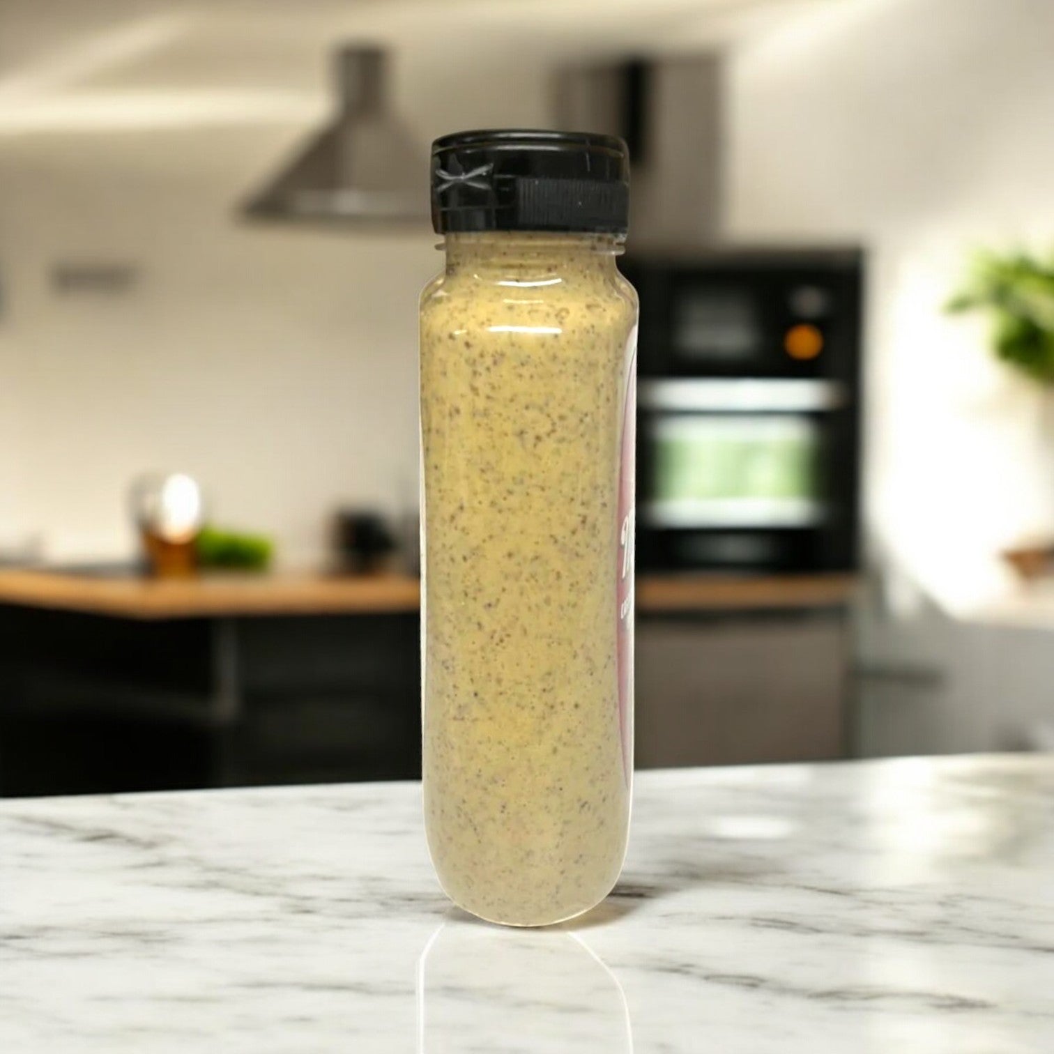 A tall bottle of Manny's Deli Horseradish Mustard, with its bold and tangy flavor, stands on a marble countertop in a modern kitchen.