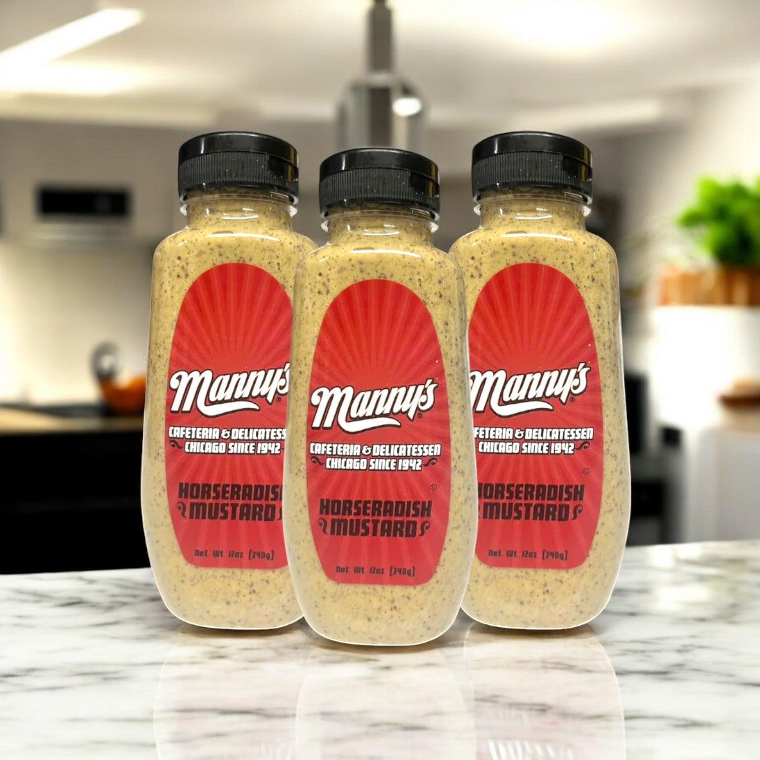 Three bottles of Manny's Deli Horseradish Mustard add a bold and tangy twist to any kitchen setting, sitting on a marble counter with their distinctive red labels.