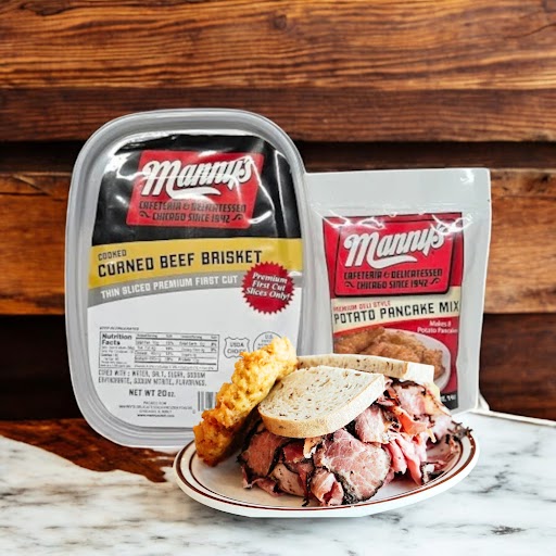 A plate featuring the Manny's 2 Count Combo with sliced corned beef sandwich on rye evokes a classic Chicago deli vibe, accompanied by containers of cooked corned beef brisket and potato pancake mix on a rustic wood surface.