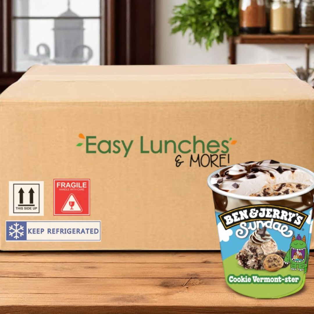 A large cardboard box labeled "Easy Lunches & More!" sits on a wooden table next to a pint of Ben & Jerry’s Cookie Vermont-Ster Sundae Ice Cream (14.4 fl oz, 6 pints), its rich fudge layer calling to your sweet tooth.