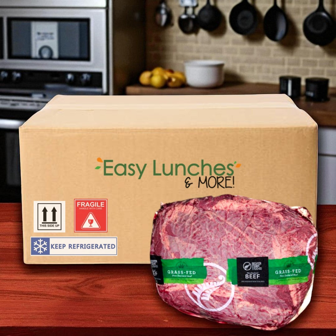 A cardboard box labeled "Easy Lunches" sits on a kitchen counter with a packaged Halal Beef Chuck Roll (14 lb average, 1 case) in front.