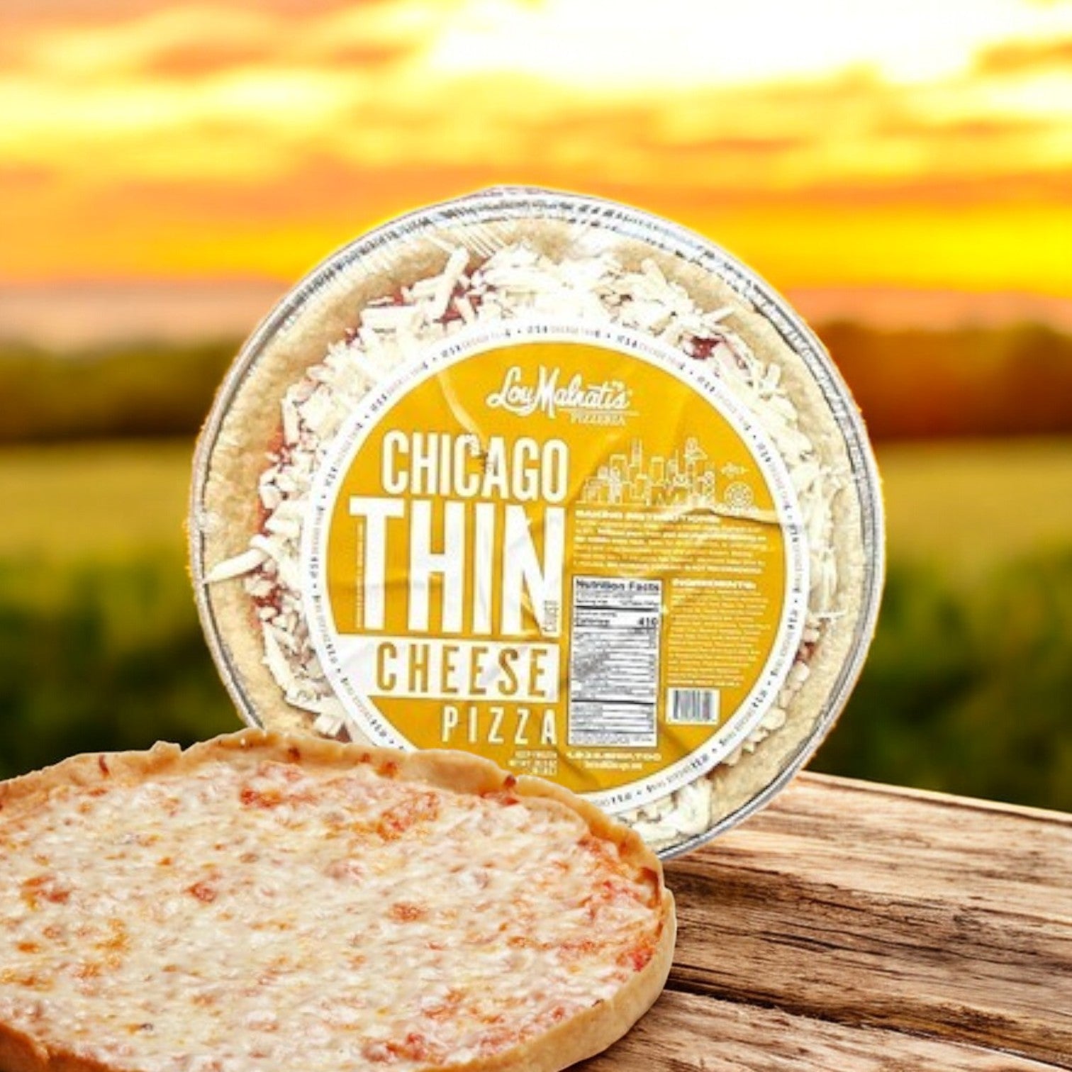 A packaged Lou Malnati's Chicago Thin Cheese Pizza, 20.5 oz., sits behind a cooked, unwrapped pizza that highlights its crispy thin crust and premium mozzarella cheese topping on a wooden surface set against a scenic background.