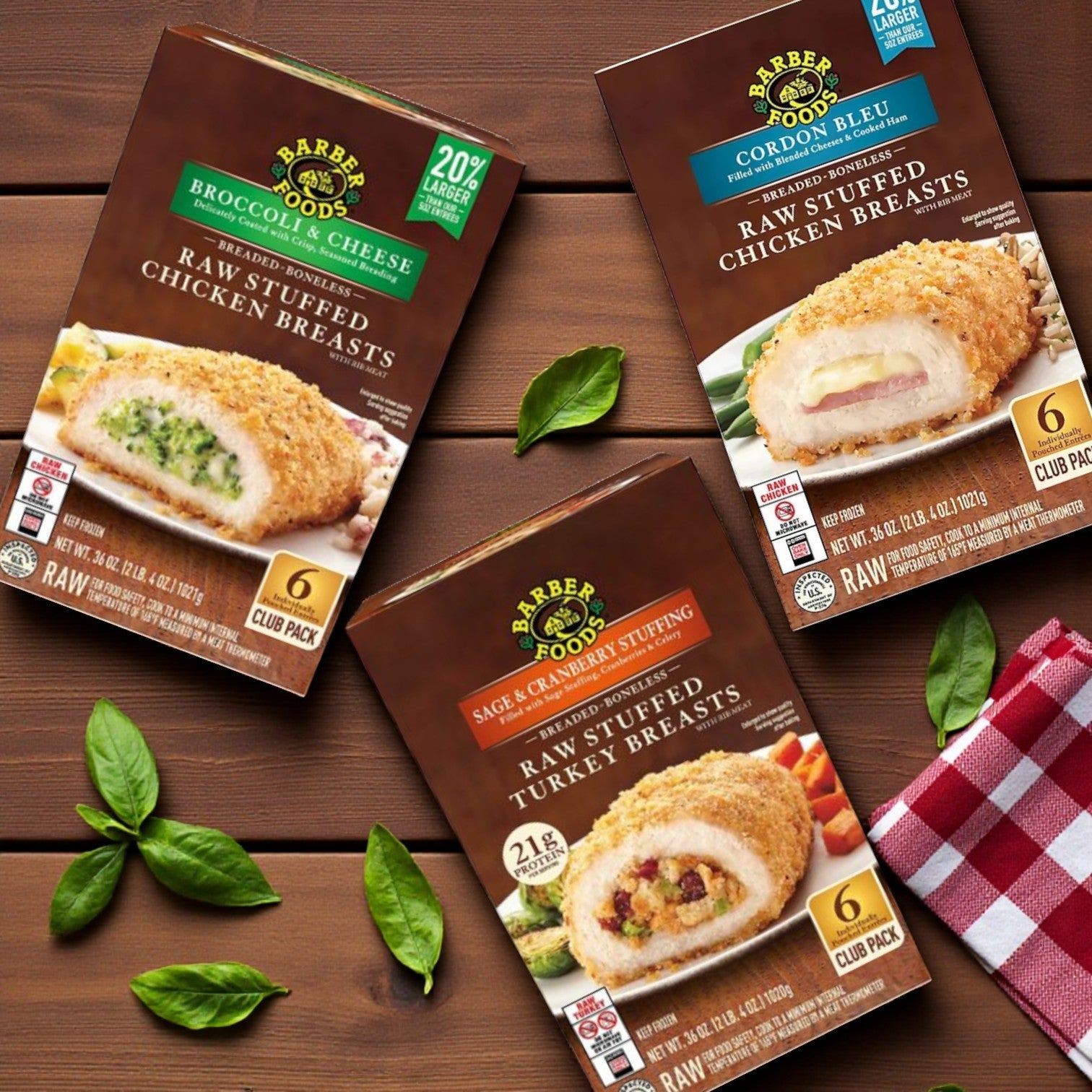 Three Sam's Club Barber Foods Stuffed Chicken & Turkey Combo Pack boxes—Broccoli & Cheese, Cordon Bleu, and Turkey & Stuffing—arranged on a wooden surface with basil leaves.