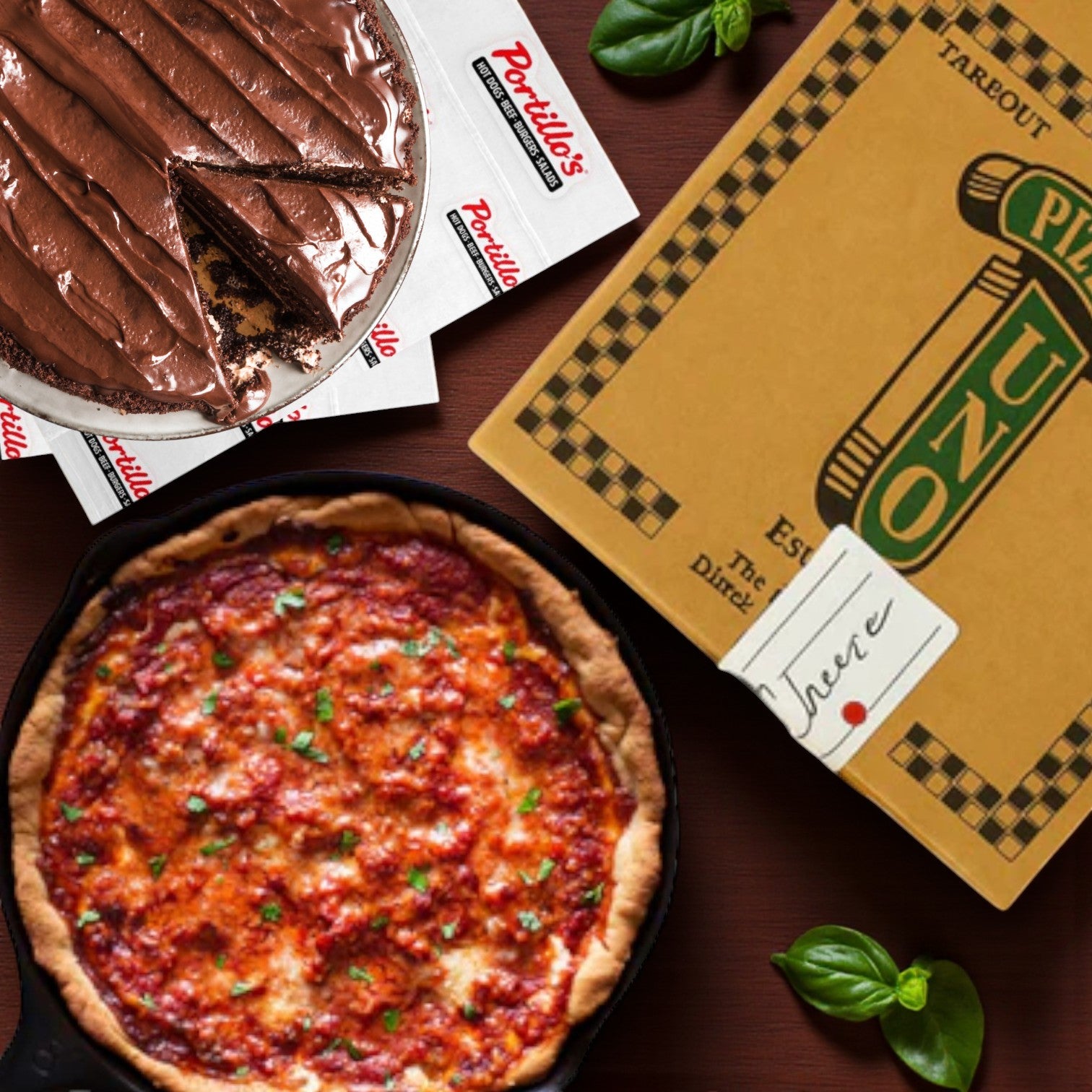 Easy Lunches features Uno’s Deep Dish Cheese Pizza (MADE IN RESTAURANT) in a skillet and Portillo’s Famous Chocolate Cake Frozen, with a pizza takeout box, napkins, and basil leaves on a wooden table.